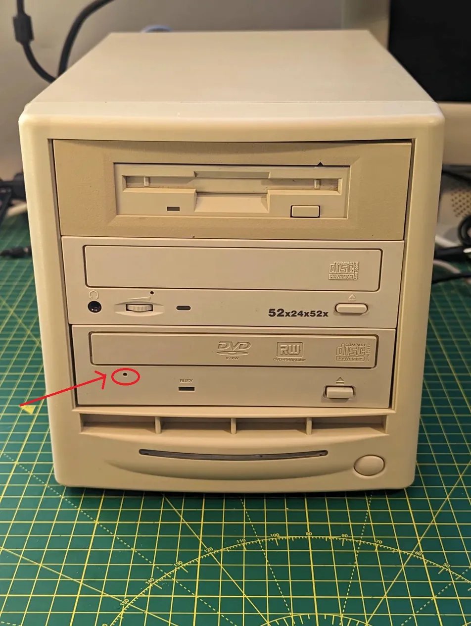 CD drive with the emergency eject hole circled in red